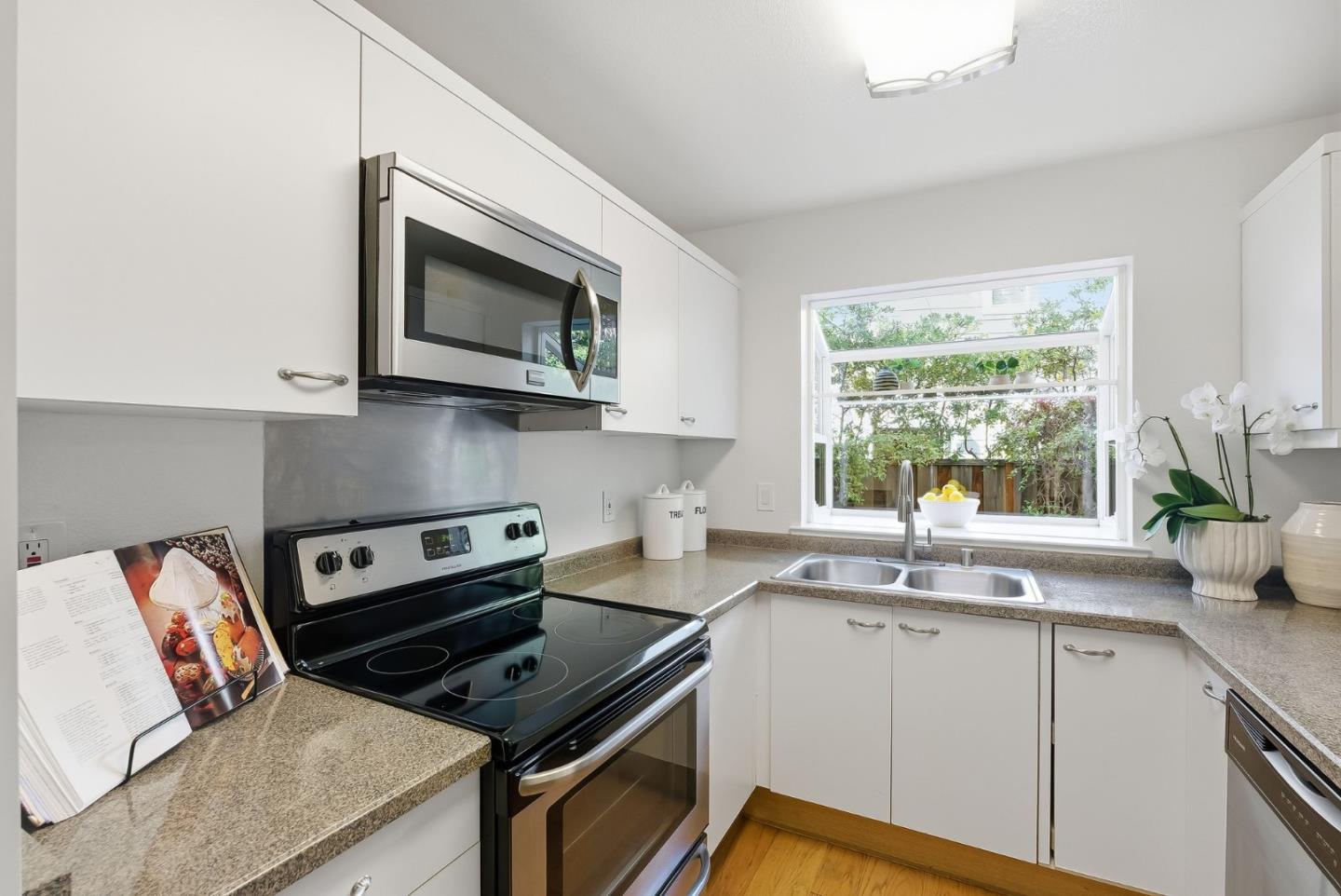 181 Ada Avenue, Unit 29 Mountain View, CA 94043 - Photo 8 of 30 a kitchen with stainless steel appliances granite countertop a sink stove and microwave