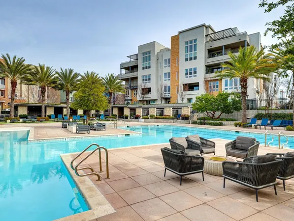 a view of a swimming pool and lounge chairs
