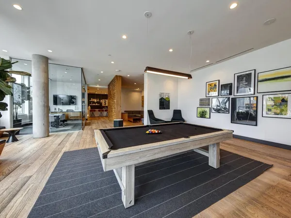 a living room with lots of furniture and a large window