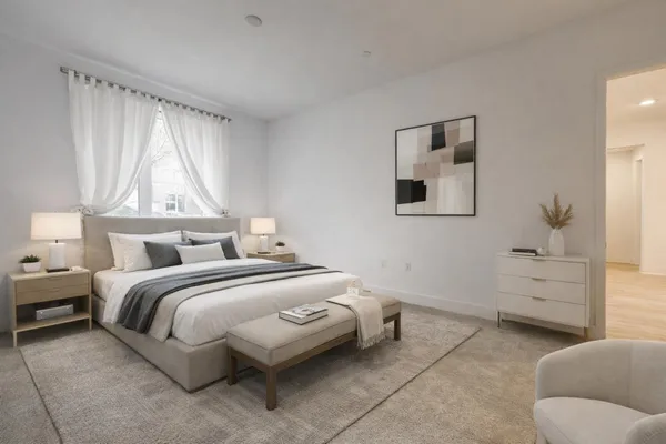 a bedroom with a bed and a window