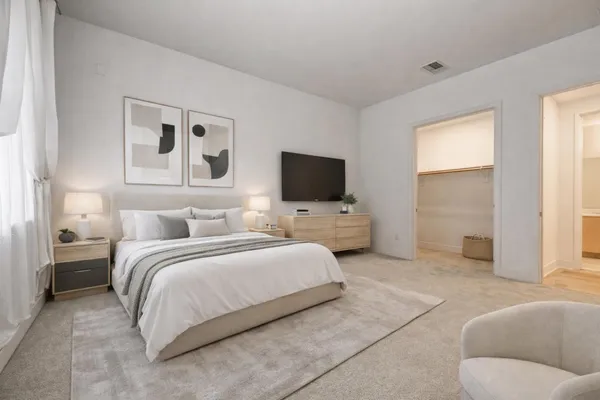 a hotel room with a bed and a television