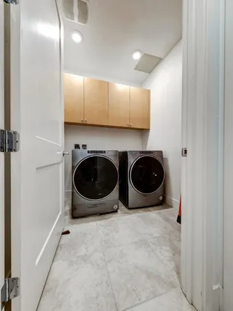 a utility room with sink dryer and washer