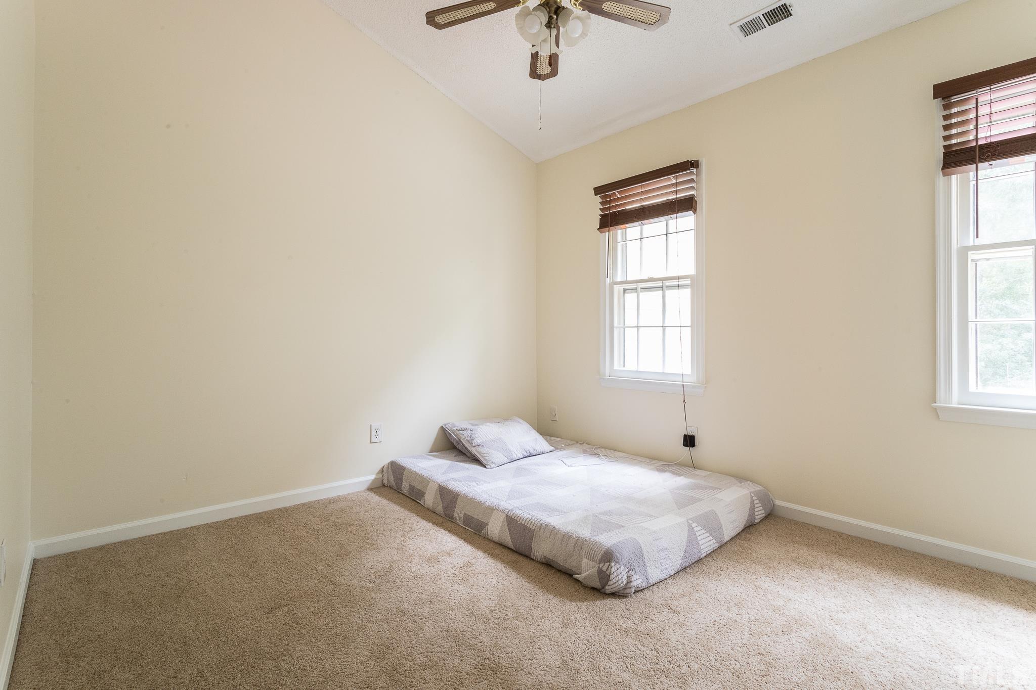2923 Faversham Place Raleigh, NC 27604 - Photo 15 of 21 a bedroom with a bed and a window