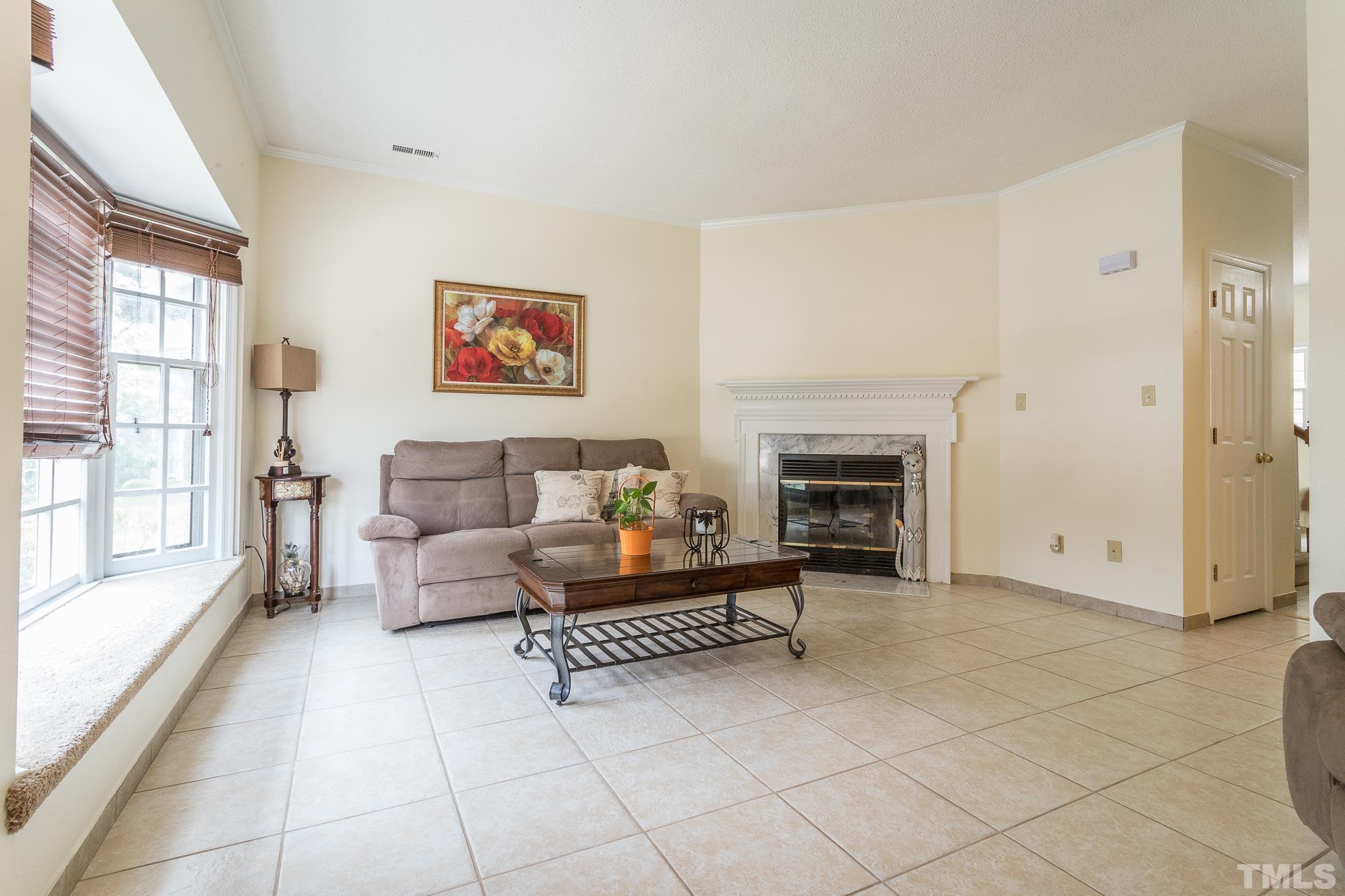 2923 Faversham Place Raleigh, NC 27604 - Photo 3 of 21 a living room with furniture and a fireplace