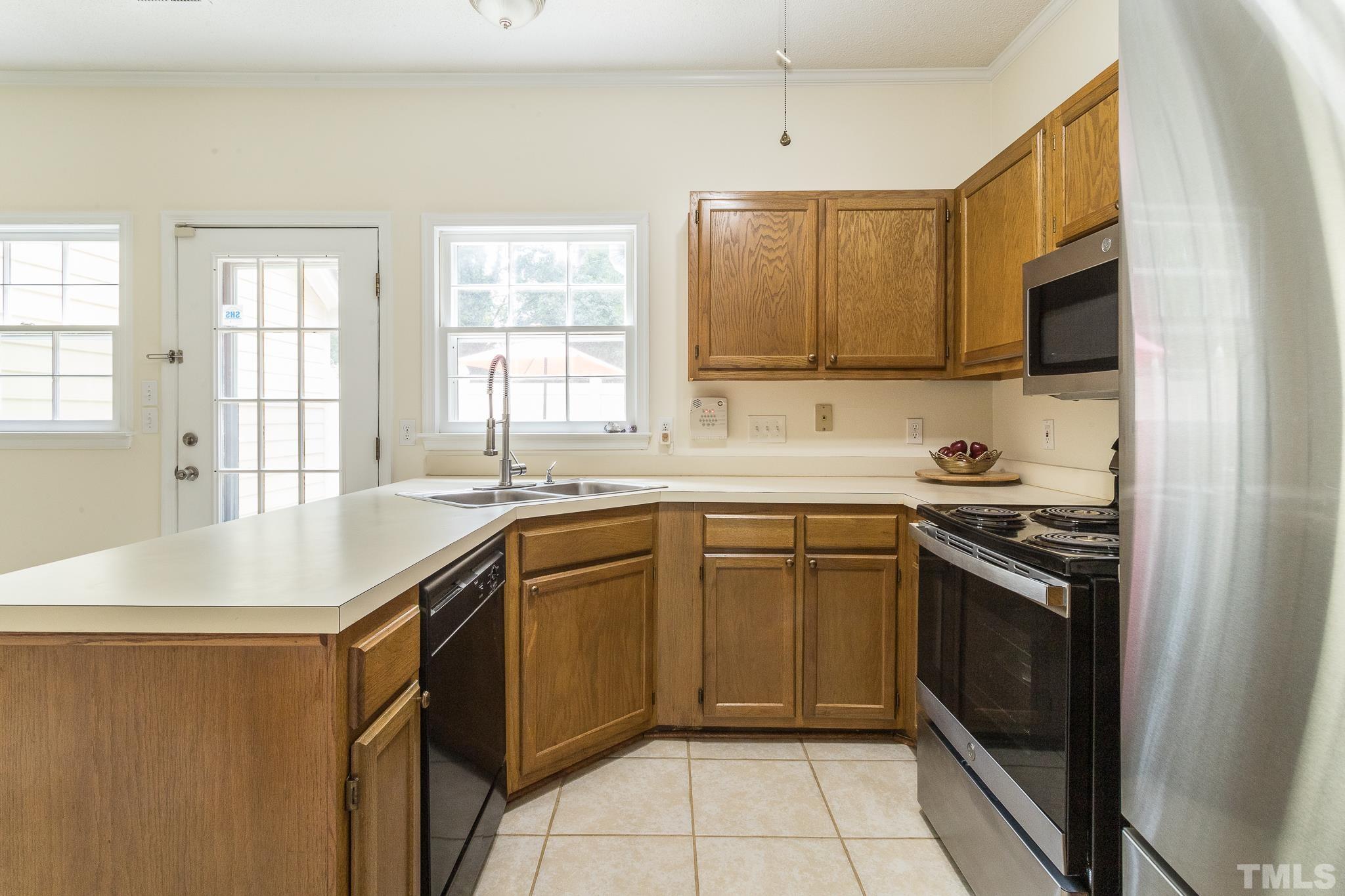 2923 Faversham Place Raleigh, NC 27604 - Photo 7 of 21 a kitchen with a sink stove and microwave