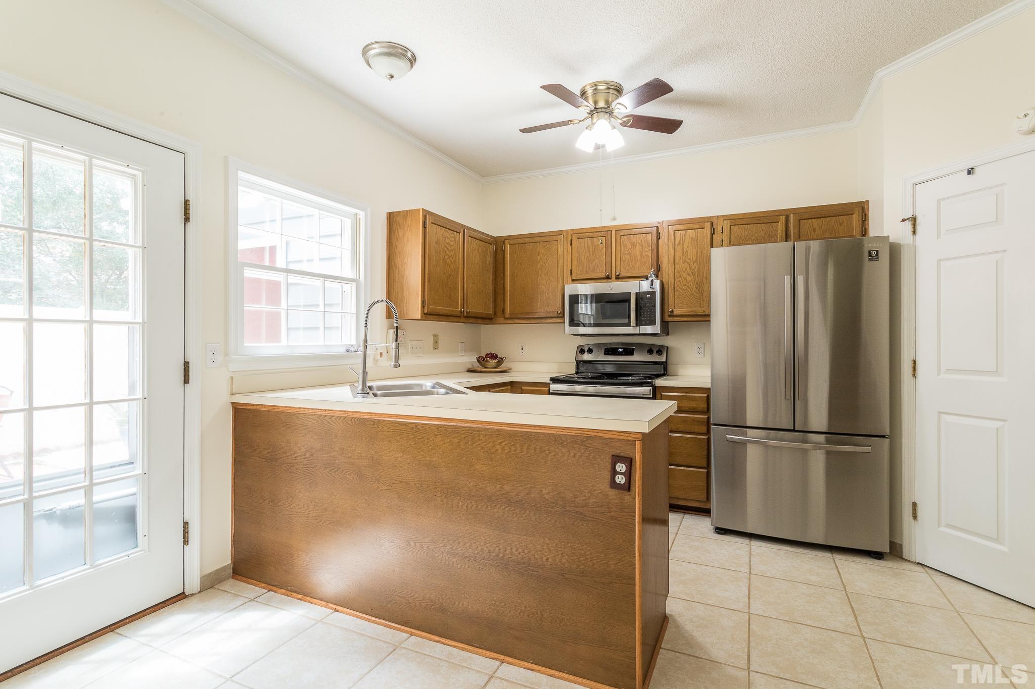 2923 Faversham Place Raleigh, NC 27604 - Photo 8 of 21 a kitchen with stainless steel appliances granite countertop a refrigerator a stove a sink and a refrigerator