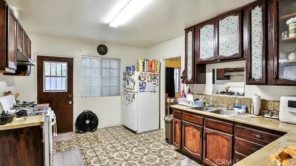 a kitchen with stainless steel appliances granite countertop a refrigerator and a stove top oven