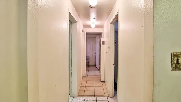 a bedroom with a bed and a dresser next to a window