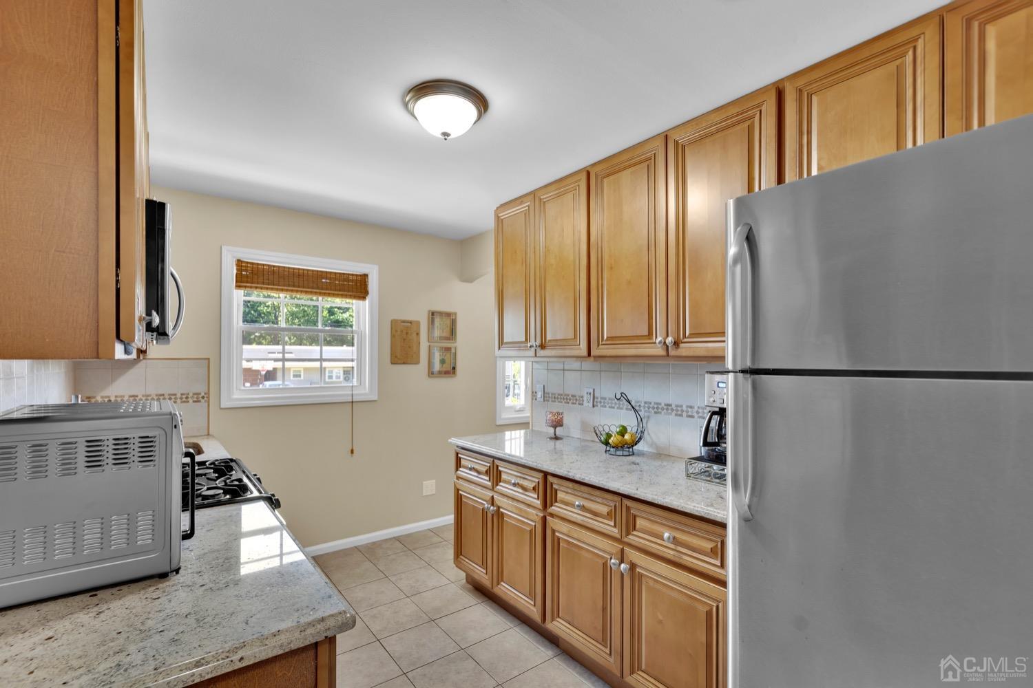 10 Rutgers Road Old Bridge, NJ 08859 - Photo 8 of 18 a kitchen with stainless steel appliances granite countertop a refrigerator sink and cabinets