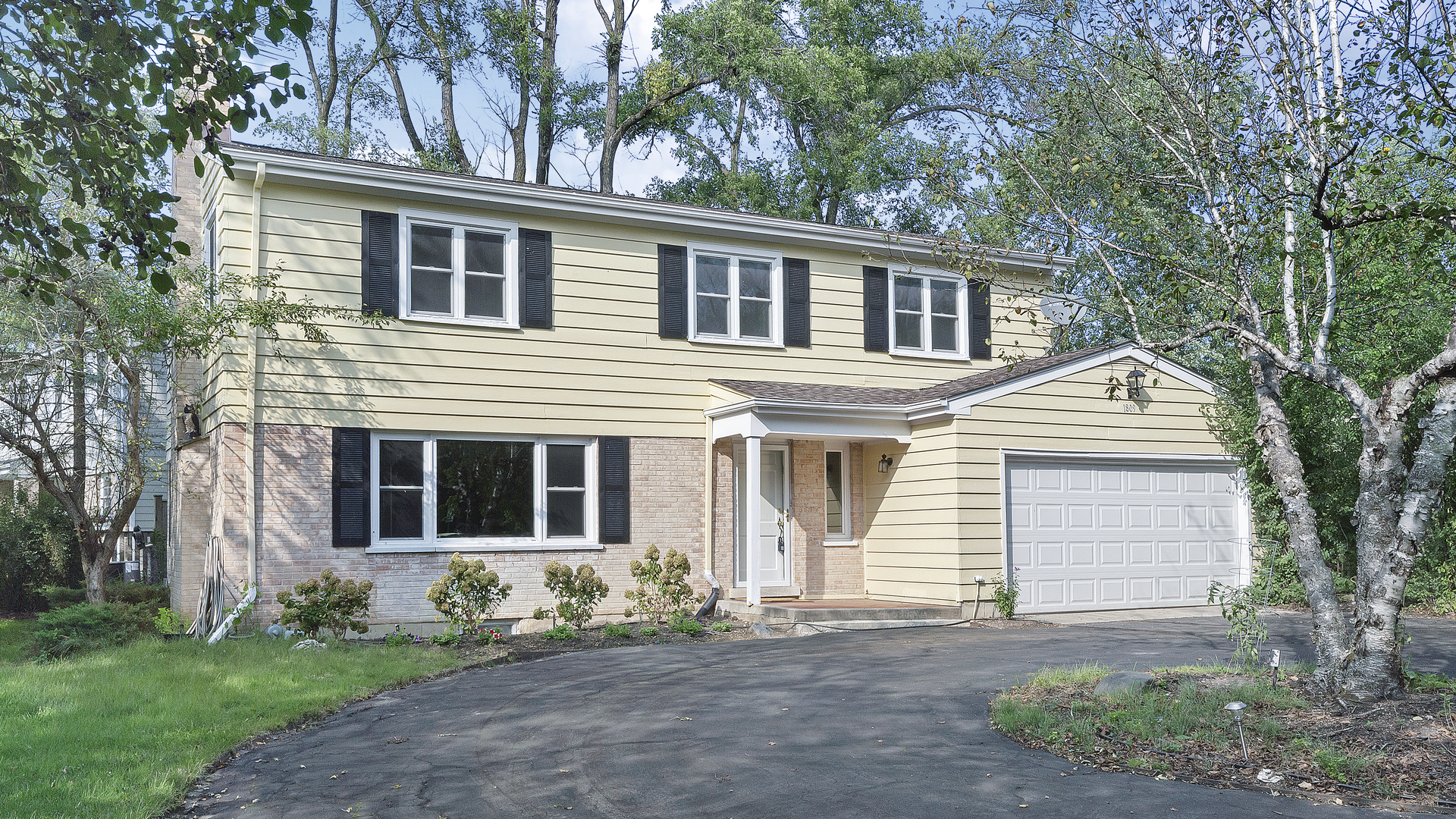 1809 Winnetka Road Northfield, IL 60093 - Photo 1 of 27 a front view of a house with a garden