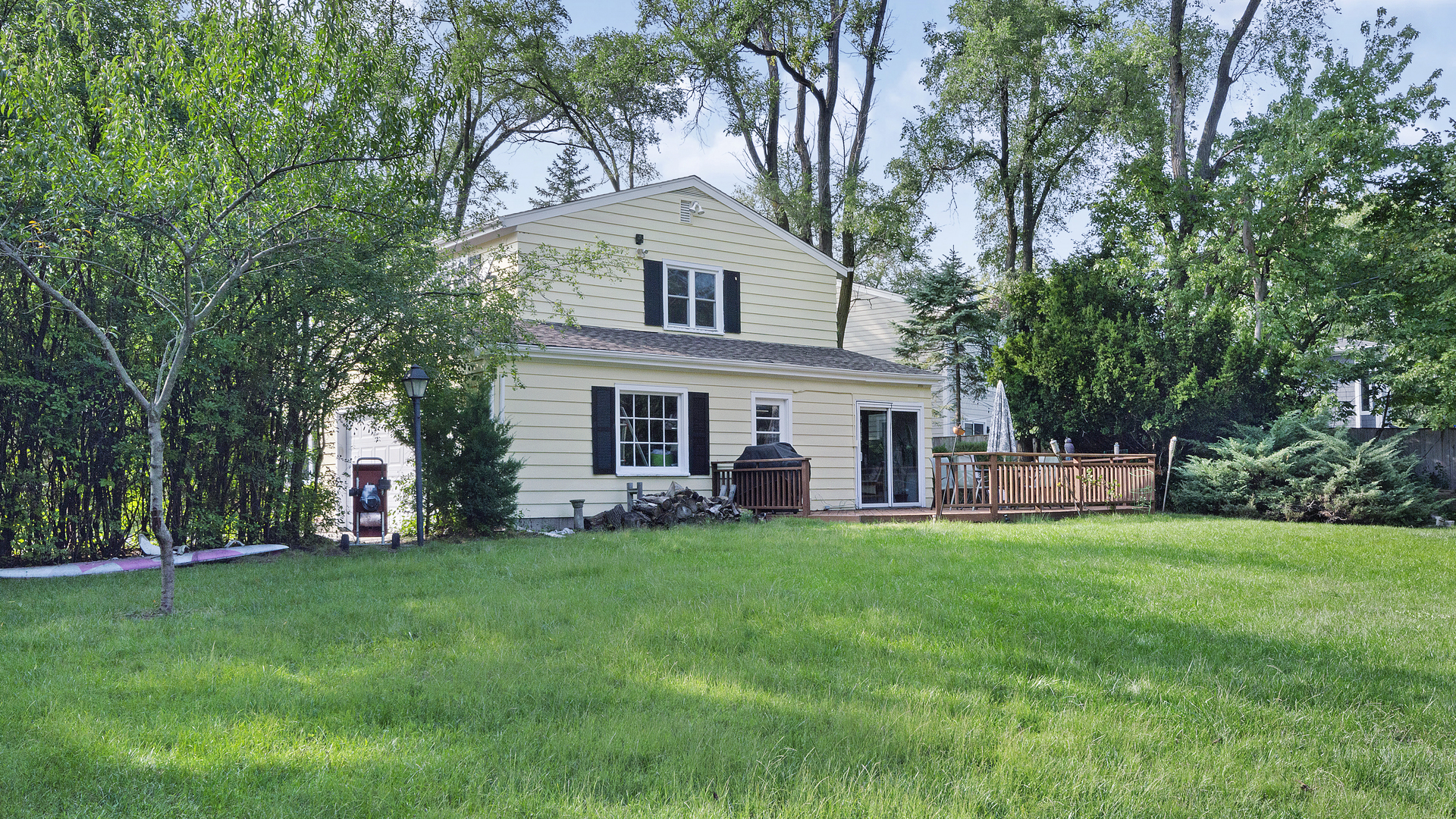 1809 Winnetka Road Northfield, IL 60093 - Photo 2 of 27 a front view of a house with a garden and trees