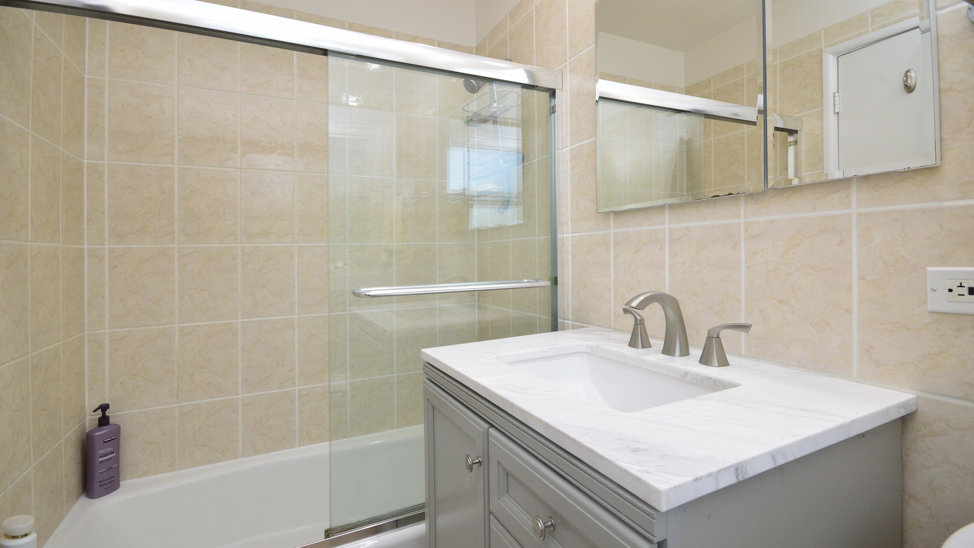 1809 Winnetka Road Northfield, IL 60093 - Photo 18 of 27 a bathroom with a sink and a mirror