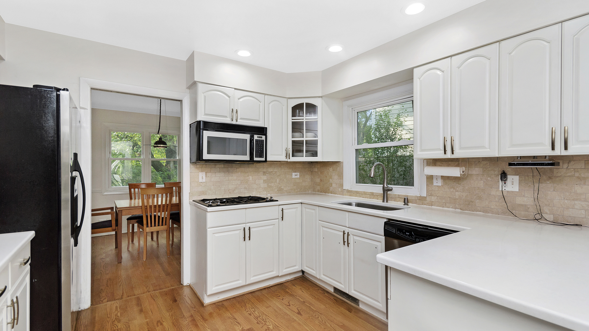 1809 Winnetka Road Northfield, IL 60093 - Photo 10 of 27 a kitchen with stainless steel appliances a stove a sink a microwave a refrigerator a stove and white cabinets