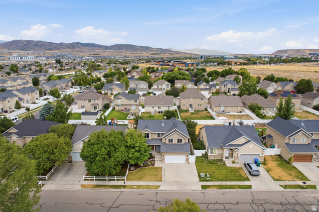 2223 North Pointe Meadow Loop Lehi, UT 84048 - Photo 48 of 56 Aerial perspective of a residential neighborhood featuring homes with dark shingle roofs, landscaped yards, and concrete driveways