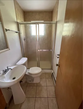 a bathroom with a toilet and a shower