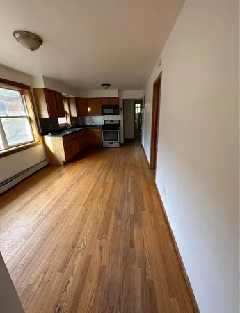 a view of living room with furniture and wooden floor