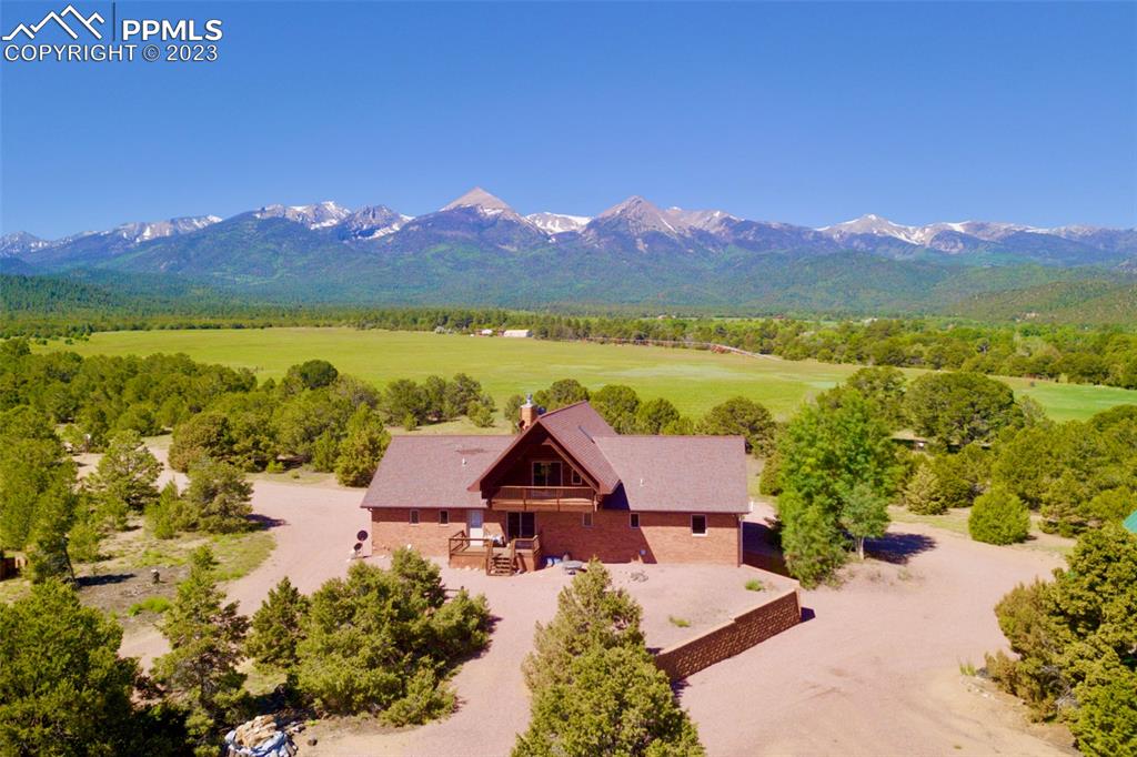 an aerial view of a house with a yard and lake view