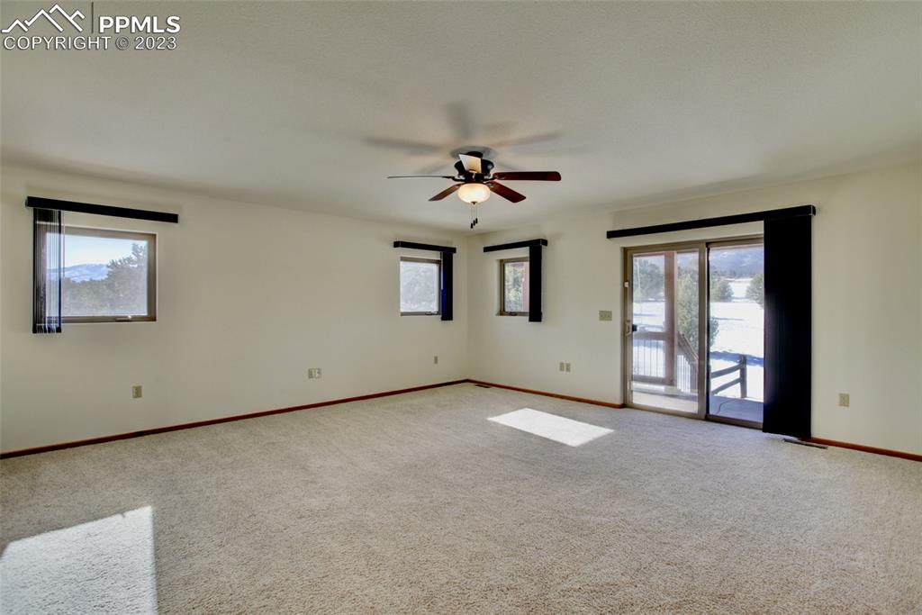1001 Three Streams Road Howard, CO 81233 - Photo 18 of 49 an empty room with chandelier fan and windows