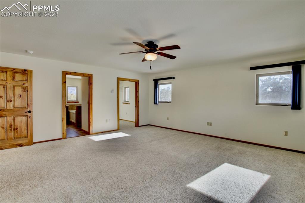 1001 Three Streams Road Howard, CO 81233 - Photo 20 of 49 an empty room with chandelier fan and windows