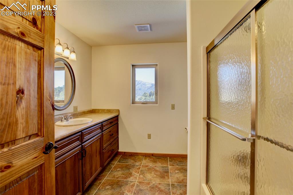 1001 Three Streams Road Howard, CO 81233 - Photo 26 of 49 a bathroom with a granite countertop sink a mirror and a shower