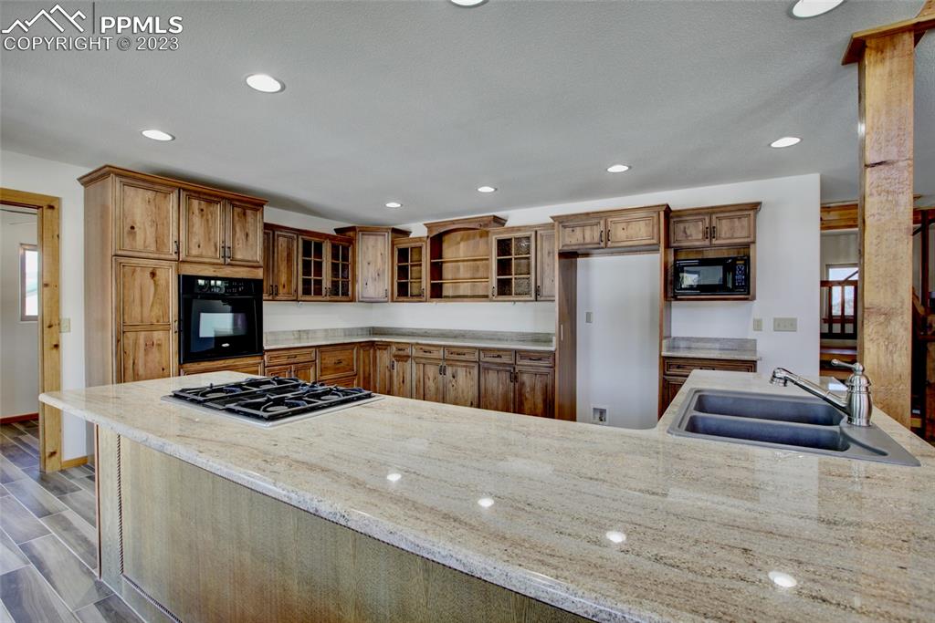 1001 Three Streams Road Howard, CO 81233 - Photo 8 of 49 a kitchen with stainless steel appliances granite countertop a stove refrigerator and a sink
