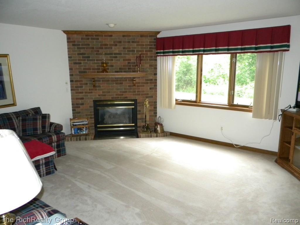 3116 Rivers Edge Drive Wayne, MI 48184 - Photo 23 of 33 Family Room in Walkout basement. Note the Gas fireplace. Beautiful views of wooded yard.