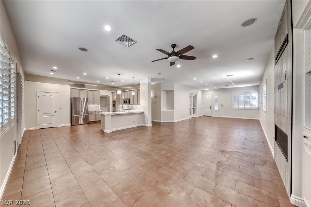 2122 Mooreview Street Henderson, NV 89012 - Photo 16 of 44 An open-concept living area features a modern kitchen and abundant natural light.
