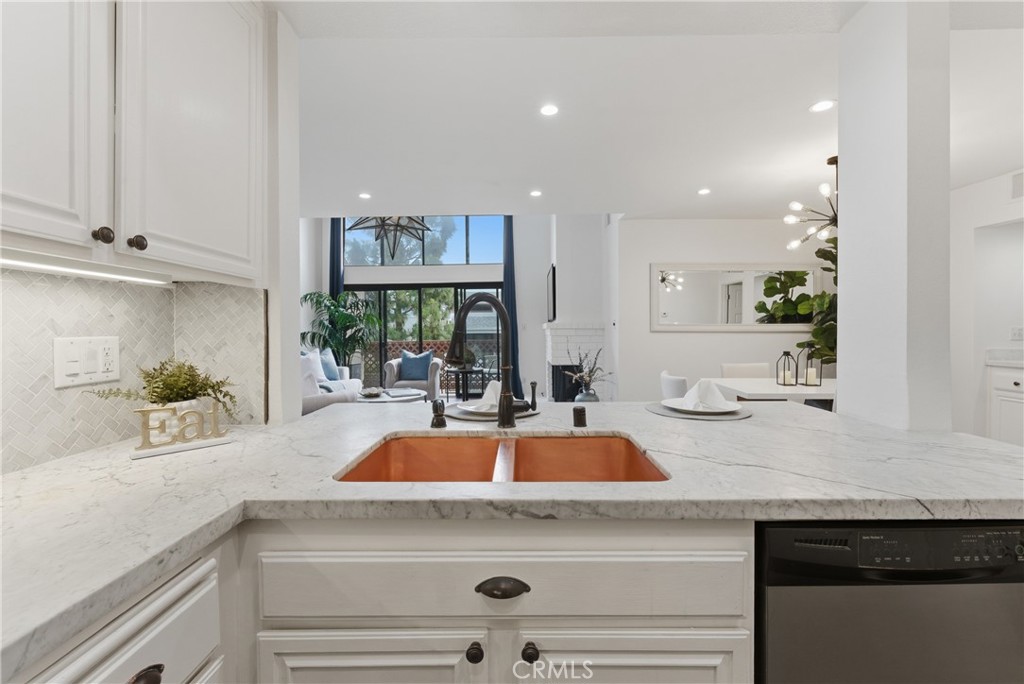 8180 Manitoba Street, Unit 330 Playa del Rey, CA 90293 - Photo 10 of 31 a view with granite countertop a sink white cabinets and a granite counter top