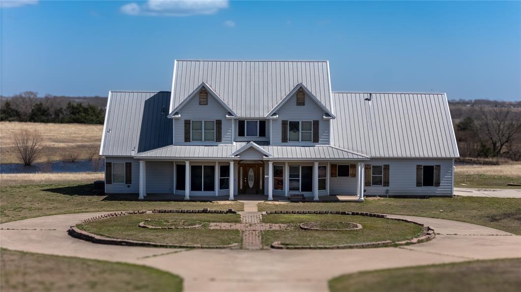 1408 Hackberry Road Van Alstyne, TX 75495 - Photo 4 of 6 a front view of a house with garden