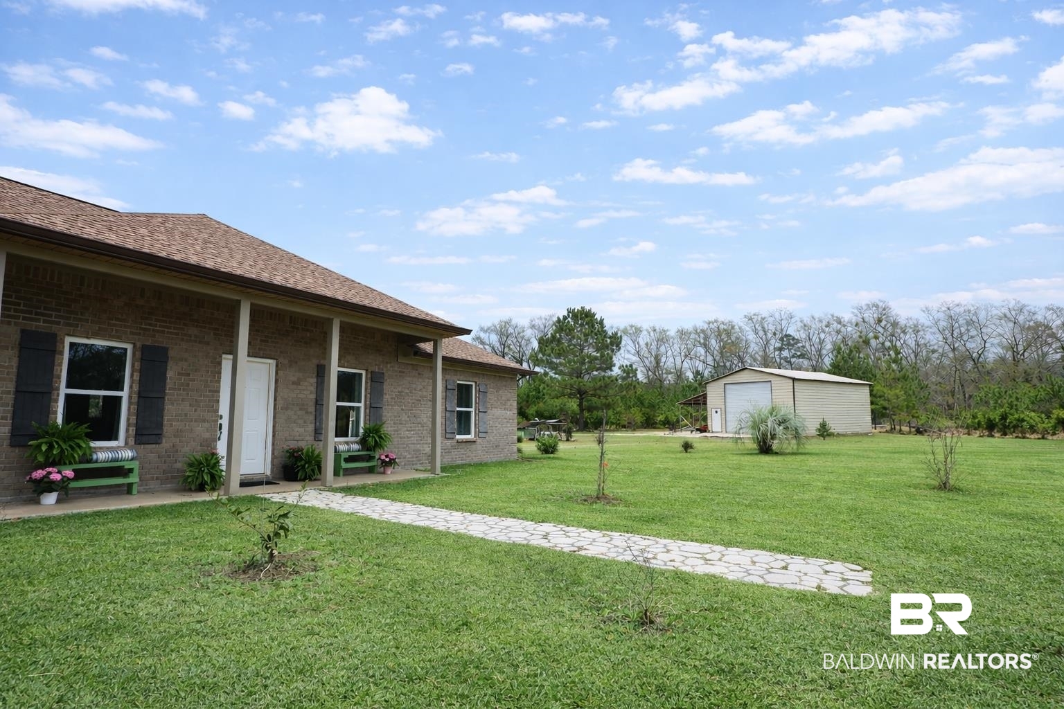 18255 Cactus Court Elberta, AL 36530 - Photo 2 of 53 View of grassy yard featuring an outbuilding and covered porch