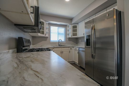 420 Lenore Street Ridgecrest, CA 93555 - Photo 7 of 29 a kitchen with stainless steel appliances granite countertop a refrigerator and a sink