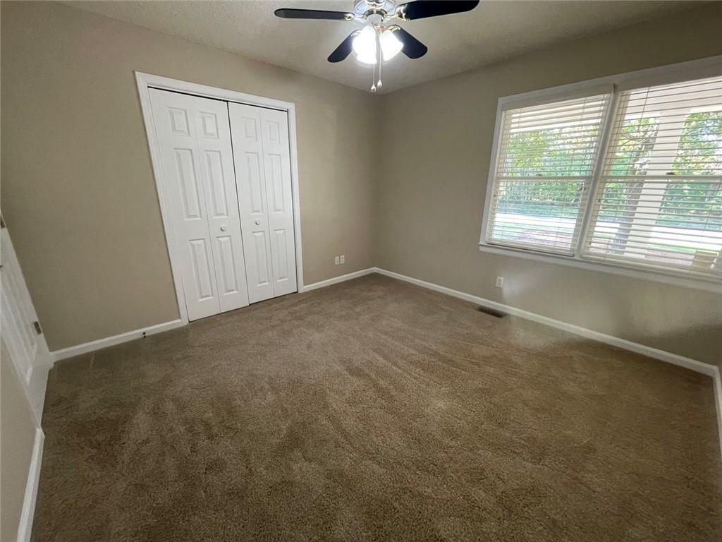 31 Williamsburg Drive Northwest Rome, GA 30165 - Photo 25 of 33 an empty room with windows and chandelier fan