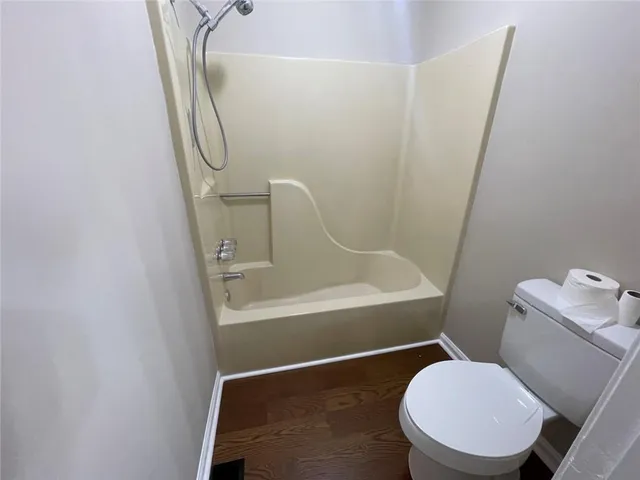 a bathroom with a toilet and a shower