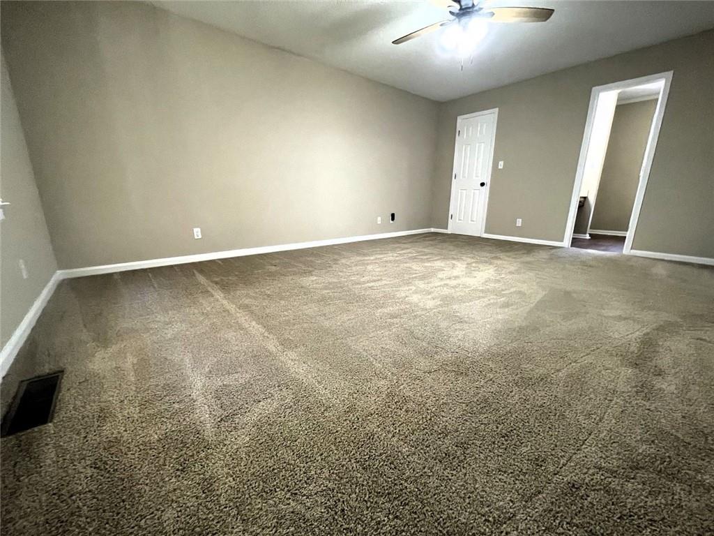 31 Williamsburg Drive Northwest Rome, GA 30165 - Photo 29 of 33 an empty room with a chandelier fan and windows