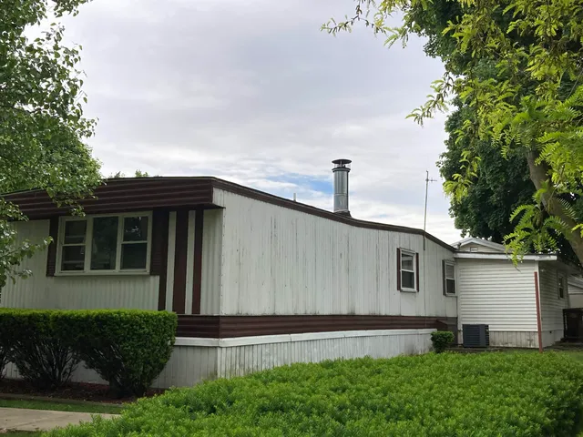 a front view of a house with a yard and table and chairs