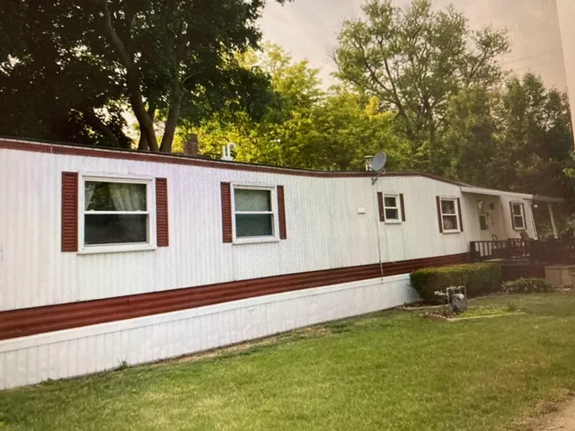 a backyard of a house with wooden floor and fence