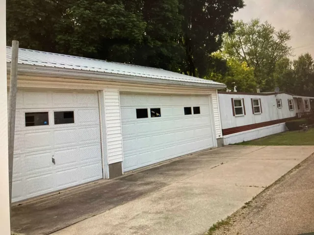 a view of a white house with a yard
