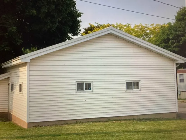 a view of a house with a yard and garage