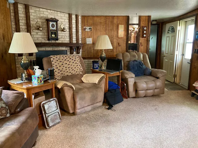 a living room with furniture and a lamp