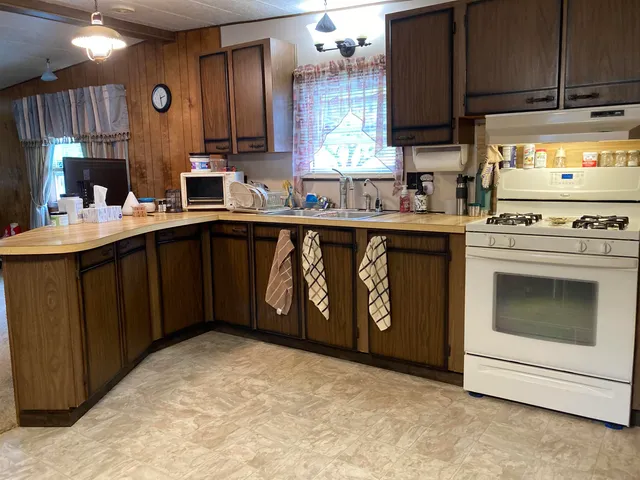 a kitchen with a stove a sink and a microwave