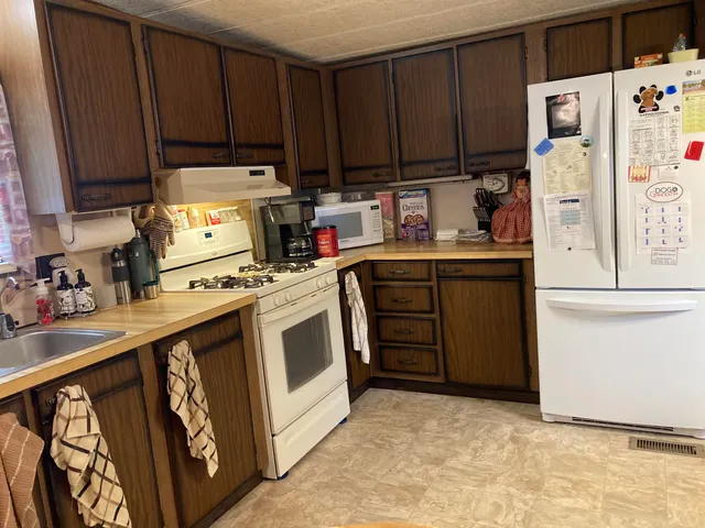 a kitchen with cabinets a sink and appliances
