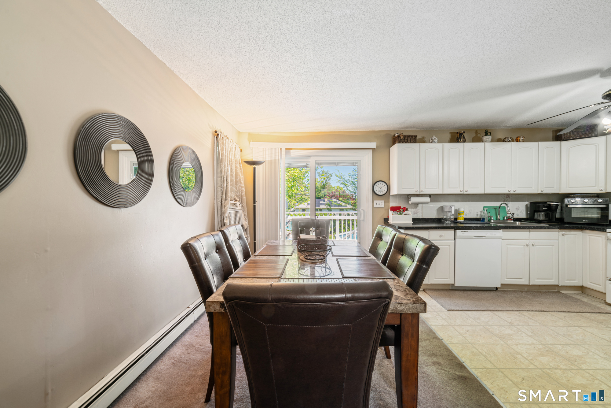 146 Highland Drive Waterbury, CT 06708 - Photo 10 of 31 a view of a dining room with furniture a kitchen view and a window