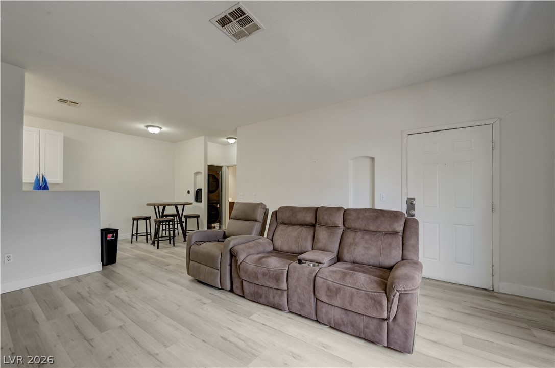 4730 East Craig Road, Unit 1155 Las Vegas, NV 89115 - Photo 7 of 41 Bright vinyl plank flooring extends through this open-concept living space with subtle recessed lighting.