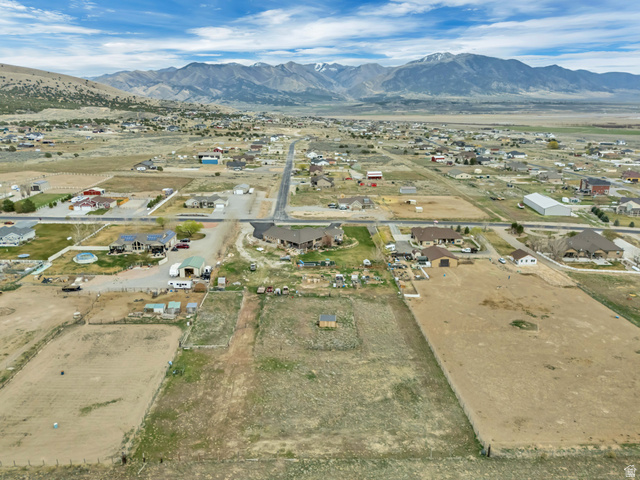 3054 West Ridgeline Road Stockton, UT 84071 - Photo 73 of 88 Aerial view of property's location with a mountain backdrop and nearby suburban area
