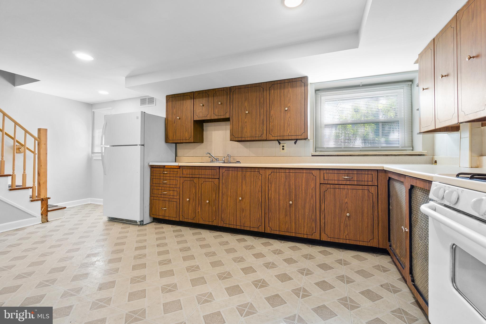 3572 Juneway, Unit 1 Baltimore, MD 21213 - Photo 8 of 23 a kitchen with stainless steel appliances a sink and a refrigerator