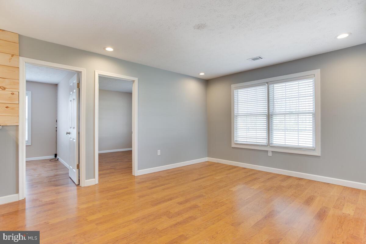 622 Old Love Point Road Stevensville, MD 21666 - Photo 19 of 38 Living room with doors to bedroom #3 and bedroom#4