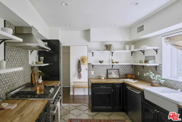 a kitchen with granite countertop a stove and a sink