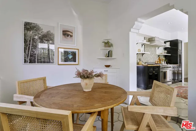 a view of hallway with livingroom and wooden floor