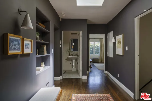 a bedroom with a bed and a mirror