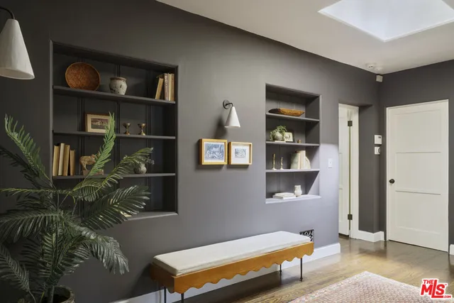 a spacious bedroom with a bed and a chandelier